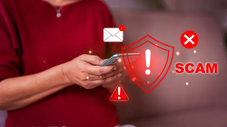 A person using a phone with scam pop-up visuals.
