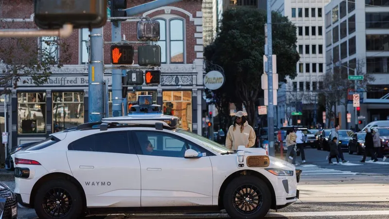 A white Waymp vehicle waiting at a Chicago intersection.