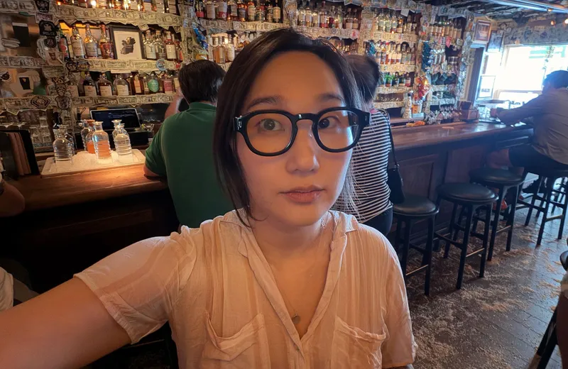 Senior reviewer Victoria Song modeling the Halliday Gen 2 glasses in a bar.