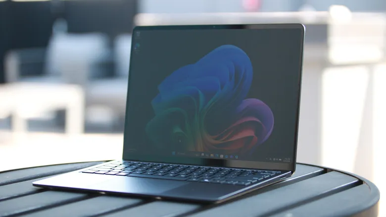 A slightly off angle view of the Surface Laptop sitting on a table on a rooftop patio.