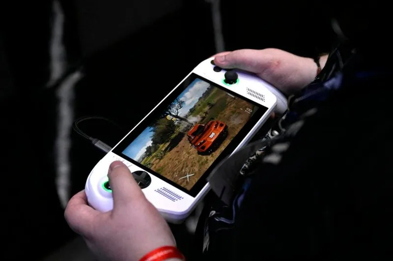 A visitor plays the Forza Horizon 5 video game on a ROG Xbox Ally X from ASUS and Xbox at the Xbox booth during the Gamescom video games trade fair at the Trade Fair Center in Cologne, western Germany, on the first day of the fair on August 20, 2025. The 2025 edition of the vast Gamescom trade fair in Cologne, Germany, had its opening night on August 19, 2025 and will be running from August 20 to 24, 2025. (Photo by Ina FASSBENDER / AFP) (Photo by INA FASSBENDER/AFP via Getty Images)          
