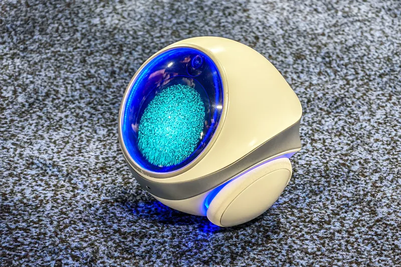 Photo of FrontierX’s Aura robot on a carpet