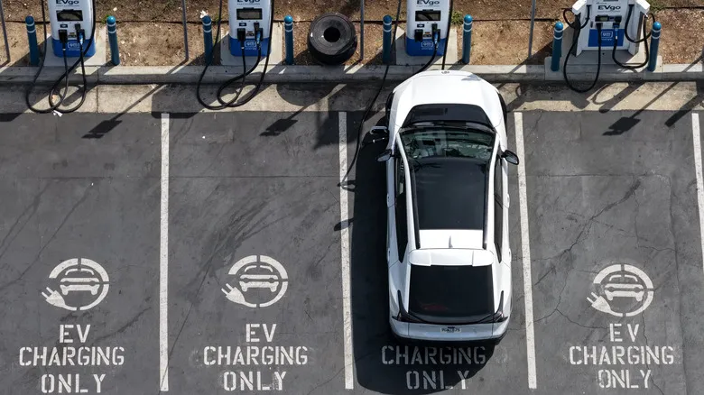 Electric car plugged into charging station